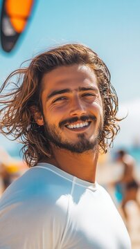 Close-up portrait of a smiling young man with flowing hair, kite surfing under a bright blue sky and sunny day by the ocean