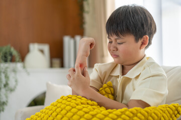 Young asian boy concerned expression itch or skin irritation, children allergy, particularly those...