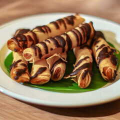 Crispy Chocolate Drizzled Spring Rolls on a Plate