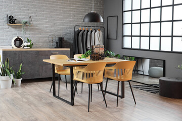 Interior of clothing store office with table, rack and counters