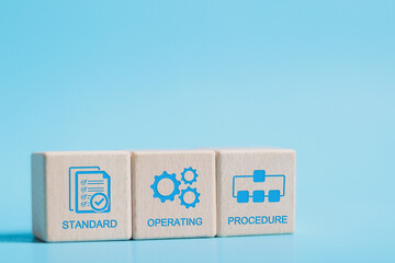 SOP, Standard operating procedure concept. SOP icon on wooden block for the standard operating procedure with instruction, quality, process, operation, sequence, workflow.