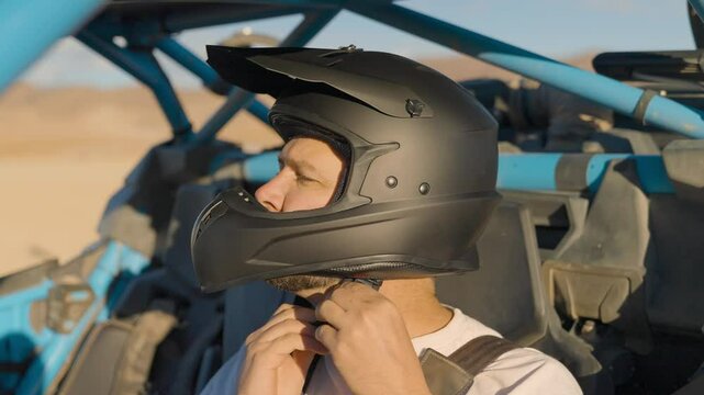 Man buckling helmet