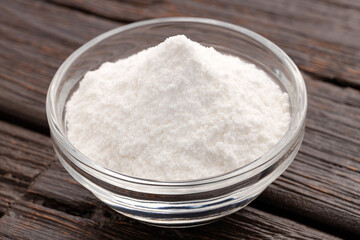Baking soda powder in the bowl - Healthy food.