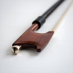 Fototapeta premium Exquisite wood and brass violin bow showcasing craftsmanship and artistic detail, photography of still life concept.