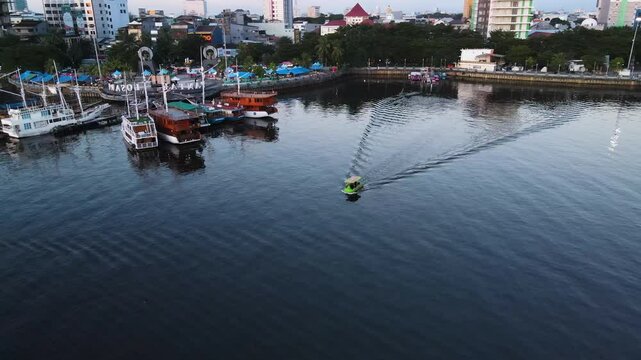 Boats Docked at the Iconic Pantai Losari Pier in Makassar, Sulawesi, Indonesia - Aerial Pullback Shot