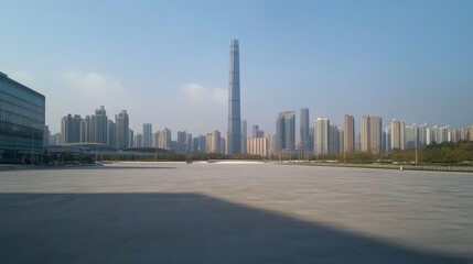 31.An empty, expansive square floor overlooking the modern cityscape of Guangzhou, with tall skyscrapers and sleek glass buildings under a clear sky. The scene captures the smooth, open road leading