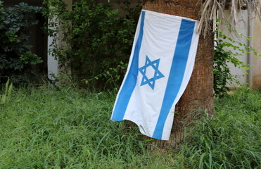 White and blue flag of Israel with the Star of David.