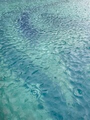 view of the pool during strong wind and rain