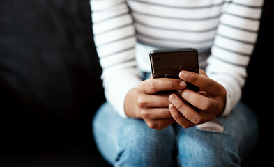Hands, woman and texting on smartphone with message or update profile on social media in dark background. Closeup, female person and internet connection for website access and email notification