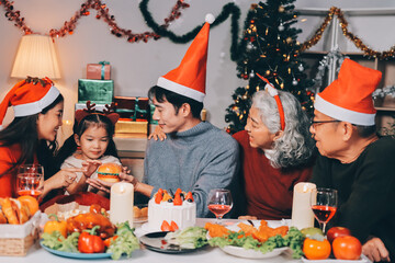 Happy multigeneration family enjoying in opening gifts on Christmas eve at home.