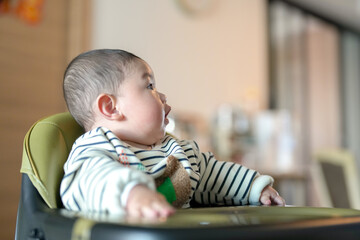 A 6-month-old boy has his mouth wiped by his mother from a Chinese family on a cold winter day in an apartment building in Pudong New District, Shanghai, China.