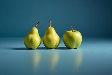 three pears are sitting on a table with a blue background