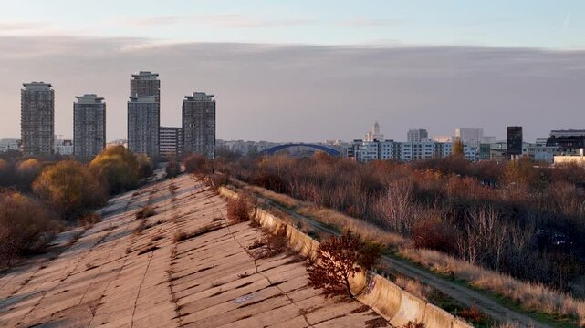 Slow Aerial Reveal of Vacaresti Delta at Sunset with Bucharest Cityscape in the Background, Romania