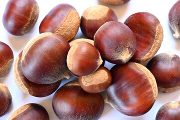 Chestnuts on white background, close-up.