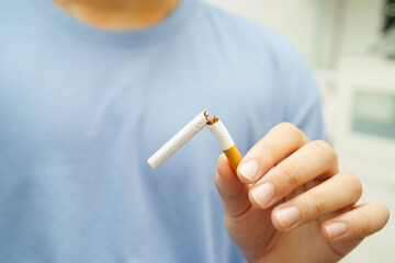 Quit smoking, Asian man breaking destroy cigarette in hand.