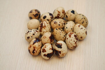 Quail eggs on a wooden table. Close-up, selective focus