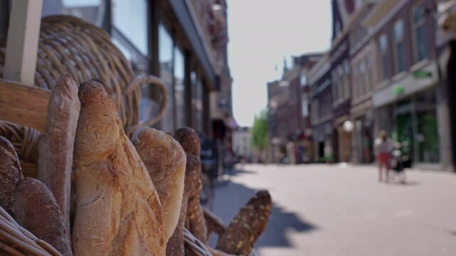  Freshly baked baguettes in a basket at a bustling market street