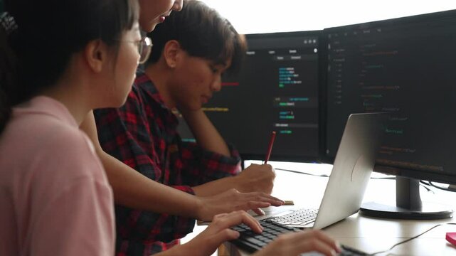 Back end software developer engineer for computer programming working together on debugging writing computing code, solving complex algorithms display on monitor in office. Burgeoning
