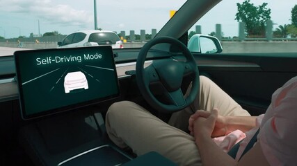 Self driving car or autonomous vehicle travel on speed highway with driverless system and autopilot mode allowing man driver relax and focus on smartphone without compromising safety. Fastidious - Powered by Adobe