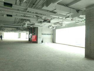 Full indoor shot of a large, empty space, likely a floor of a building under construction. System works