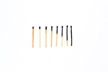 stages of wooden match sticks burn on isolated white background