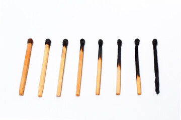 stages of wooden match sticks burn on isolated white background