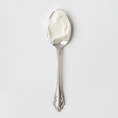 top view white yogurt on a silver spoon with a simple design isolated on a solid background. National Frozen Yogurt Day