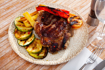 Tasty and healthy grilled beef chop dinner served with vegetable garnish..