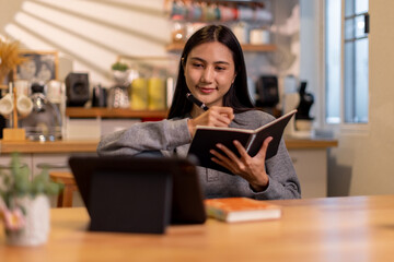 Female business freelancer asian person using digital tablet and laptop or remote working at home office, 