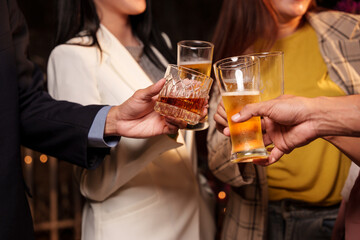 Party Celebrate whiskey at a friendly party in a restaurant. Night.