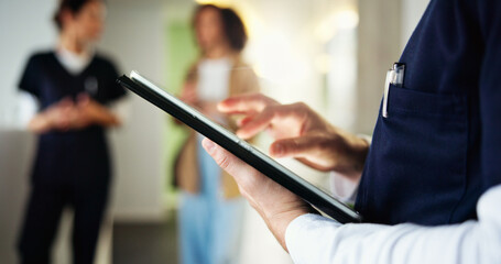 Man, dentist and hand with tablet in clinic, check medical records and appointment schedule. Male...