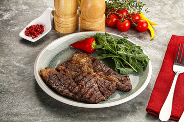 Grilled chuck roll steak with arugula