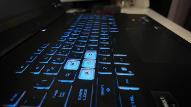 Close-up of a glowing RGB keyboard with WASD illuminated