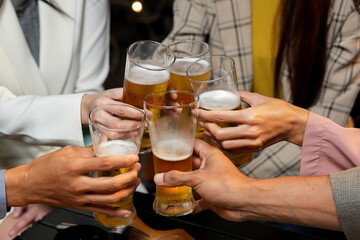 food and drink male friends are happy drinking beer and clinking glasses at a bar or pub.