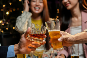food and drink male friends are happy drinking beer and clinking glasses at a bar or pub.