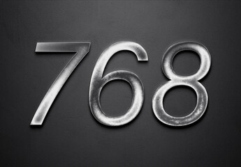 Chrome metal 3D number design of 768 on grey background.