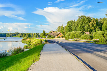 Fototapeta premium Straße am See bei Beautifully located wake park or water ski park on the lake near Põlva, Polwa with water and green trees in summer, in southern Estonia 