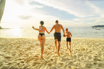 happy family running on the beach
