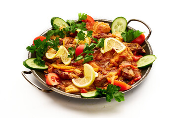 A large serving of food with a variety of vegetables and meat