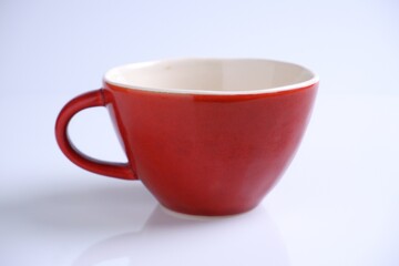 red ceramic mug isolated on white background.