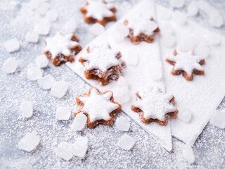 Christmas cookies (cinnamon stars) on bright background. Close up.	