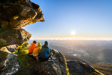 Mother with kids enjoying the sunrise view from Boroka Lookout cliff at Grampians Mountains, Victoria, Australia