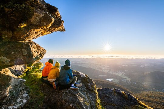 Mother with kids enjoying the sunrise view from Boroka Lookout cliff at Grampians Mountains, Victoria, Australia
