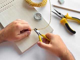 Crafting with precision. Hand tools and wire for diy projects