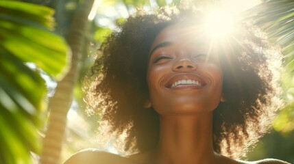 Woman Smiles Joyfully In Sunlight Among Lush Green Leaves