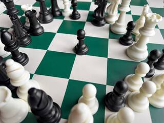 Strategic chessboard with black pawn surrounded by chess pieces