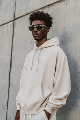 Urban Fashion Hoodie Mockup Against Textured Concrete Wall for Apparel Branding