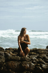 Woman on the rocks of a beach
