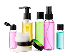 Variety of colorful personal care bottles and grooming accessories arranged on a white surface