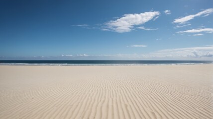 Obraz premium a sandy beach with a blue sky and white clouds